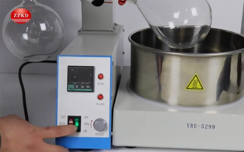 Operating a Rotary Evaporator close-up of hands operating a rotary evaporator control panel